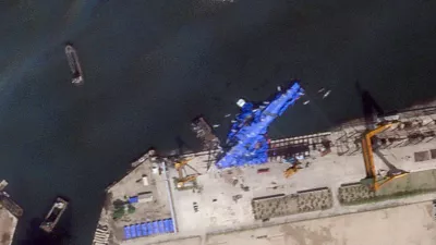 A satellite image shows a North Korean warship covered with a blue tarp after an accident that occurred during its launch at the shipyard in Chongjin, North Korea, May 23, 2025. 2025 Planet Labs PBC/Handout via REUTERS THIS IMAGE HAS BEEN SUPPLIED BY A THIRD PARTY. MANDATORY CREDIT