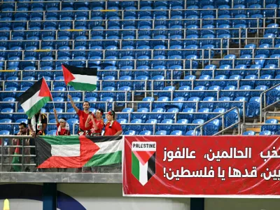 Soccer Football - World Cup - AFC Qualifiers - Group B - Kuwait v Palestine - Jaber Al-Ahmad International Stadium, Kuwait City, Kuwait - June 5, 2025 Palestine fans wave flags in the stands before the match REUTERS/Noufal Ibrahim