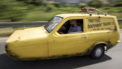 Tarik Fatic along with his brother Mirnes drives the Reliant Regal, an exact copy of the famous BBC TV show  "Only Fools and Horses" iconic yellow car in Sarajevo, Bosnia, Wednesday, June 4, 2025. (AP Photo/Armin Durgut)