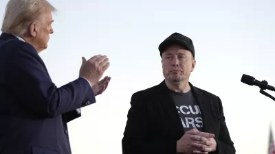 FILE - Republican presidential nominee former President Donald Trump, left, claps as Tesla and SpaceX CEO Elon Musk prepares to depart after a campaign event at the Butler Farm Show on Oct. 5, 2024, in Butler, Pa. (AP Photo/Alex Brandon, File)