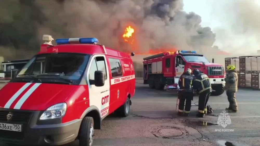 In this photo taken from video released by Russian Emergency Ministry Press Service on Saturday, June 7, 2025, Russian Emergencies Ministry firefighters extinguish the flames at a fuel and lubricants warehouse in Pushkino, Moscow region of Russia. (Russian Emergency Ministry Press Service via AP)