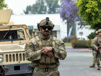 Members of the California National Guard stand guard at the Paramount Business Center parking lot a day after clashes between protesters and law enforcement following multiple detentions by Immigration and Customs Enforcement (ICE), in the Los Angeles County city of Paramount, California, U.S., June 8, 2025.  REUTERS/Jill Connelly