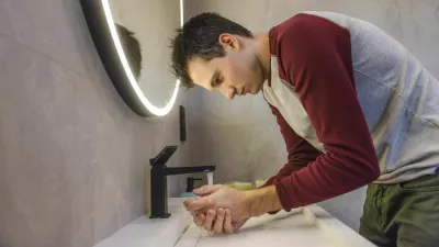 Young man carefully washes his hands in a modern bathroom, promoting hygiene, health, and responsible daily habits in a clean and organized environment. High quality photo / Foto: Stockseller_ukr