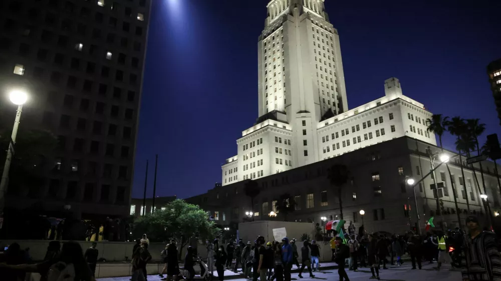 Demonstrators march outside the Los Angeles City Hall, as protests against federal immigration sweeps continue, in downtown Los Angeles, California, U.S. June 10, 2025. REUTERS/Leah Millis
