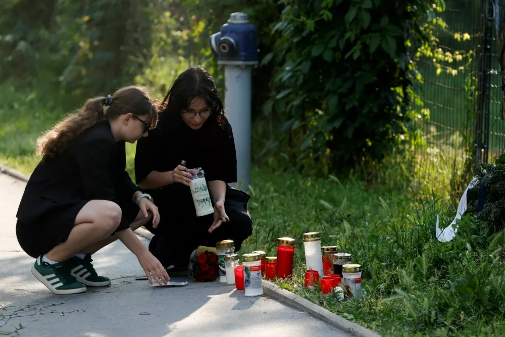People light candles outside the site of a deadly shooting at a secondary school, in Graz, Austria, June 11, 2025. REUTERS/Borut Zivulovic