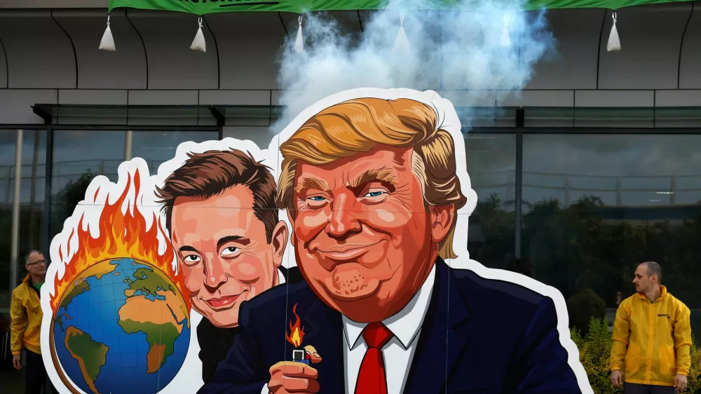 Greenpeace activists protest against the U.S. President Donald Trump and Tesla CEO Elon Musk as a part of a campaign "Time to Resist", which, according to them, is responding to the way billionaires are attacking the environment and society, in front of the Tesla dealership in Prague, Czech Republic, June 11, 2025. REUTERS/David W Cerny