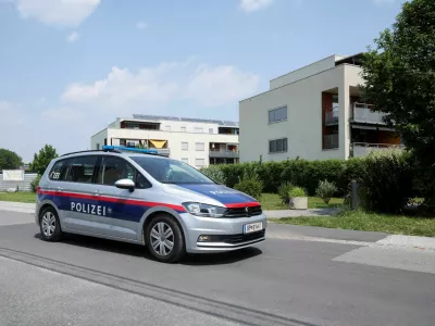 Police officers sit in a car near the flat of the suspect, in a deadly shooting at a secondary school in Graz, in Kalsdorf, Austria, June 11, 2025. REUTERS/Leonhard Foeger