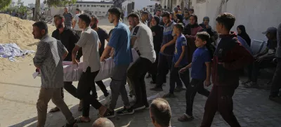 Palestinians carry the body of a person who died last night while trying to get access to humanitarian aid, near the al-Shifa Hospital, in Gaza City, Wednesday, June 11, 2025. (AP Photo/Jehad Alshrafi)