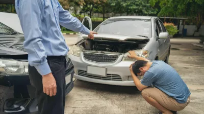 2MFE1GJ Man Upset and Sit down Motorist In Crash For Crash Insurance Fraud Getting Out Of Car