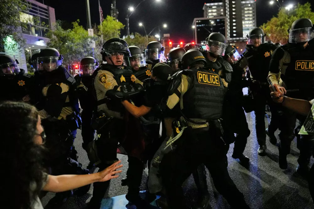 Las Vegas police detain a protester during protests over President Donald Trump's stepped-up enforcement of immigration laws, Wednesday, June 11, 2025, in Las Vegas. (AP Photo/John Locher)