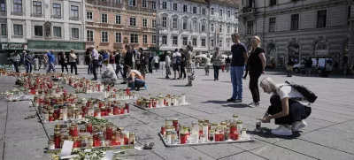 People commemorate the victims of a shooting at a school, where a former student opened fire two days before, at the central square in Graz, Austria, Thursday, June 12, 2025. (AP Photo/Darko Bandic)
