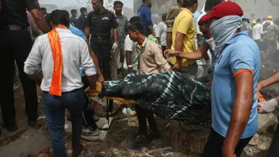 People carry the body of a victim from the crash site after an Air India Boeing 787 Dreamliner plane crashed in Ahmedabad, India, June 12, 2025. REUTERS/Amit Dave   TPX IMAGES OF THE DAY