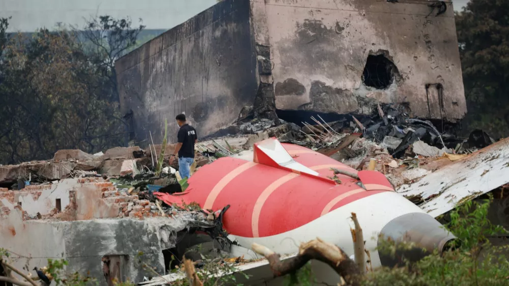 A fire offical stands next to the crashed Air India Boeing 787-8 Dreamliner aircraft, in Ahmedabad, India, June 13, 2025. REUTERS/Adnan Abidi