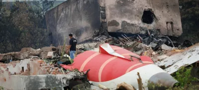 A fire offical stands next to the crashed Air India Boeing 787-8 Dreamliner aircraft, in Ahmedabad, India, June 13, 2025. REUTERS/Adnan Abidi
