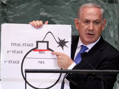 FILE PHOTO: Israel's Prime Minister Benjamin Netanyahu points to a red line he drew on the graphic of a bomb used to represent Iran's nuclear program as he addresses the 67th United Nations General Assembly at the U.N. Headquarters in New York, September 27, 2012. The red line represents a point where he believes the international community should tell Iran that they will not be allowed to pass without intervention. REUTERS/Lucas Jackson (UNITED STATES - Tags: POLITICS)/File Photo