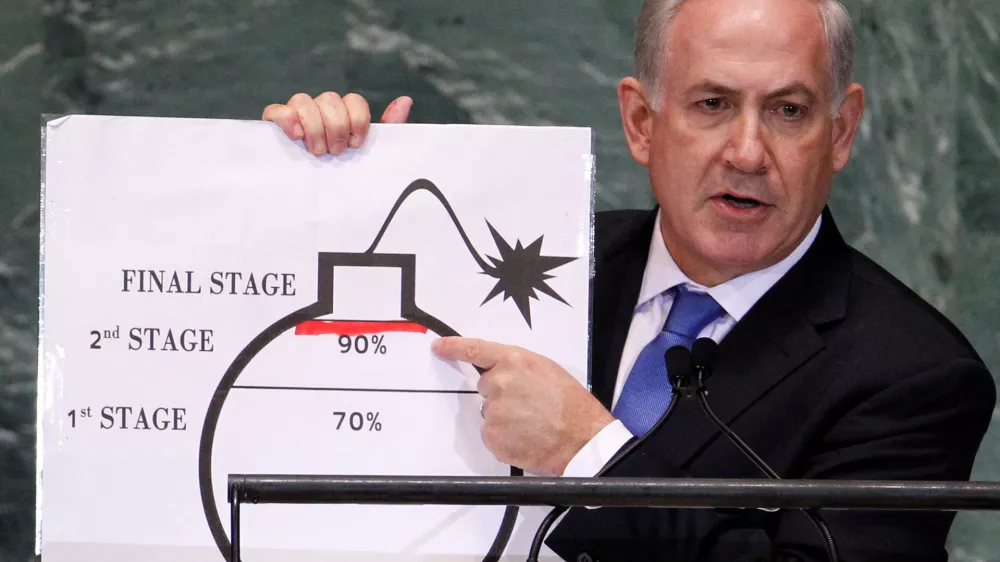 FILE PHOTO: Israel's Prime Minister Benjamin Netanyahu points to a red line he drew on the graphic of a bomb used to represent Iran's nuclear program as he addresses the 67th United Nations General Assembly at the U.N. Headquarters in New York, September 27, 2012. The red line represents a point where he believes the international community should tell Iran that they will not be allowed to pass without intervention. REUTERS/Lucas Jackson (UNITED STATES - Tags: POLITICS)/File Photo