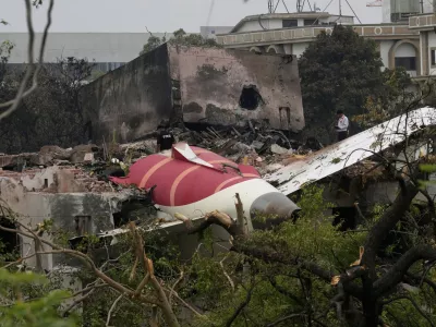 Parts of an Air India plane that crashed on Thursday are seen on top of a building in Ahmedabad, India, Friday, June 13, 2025. (AP Photo/Rafiq Maqbool)
