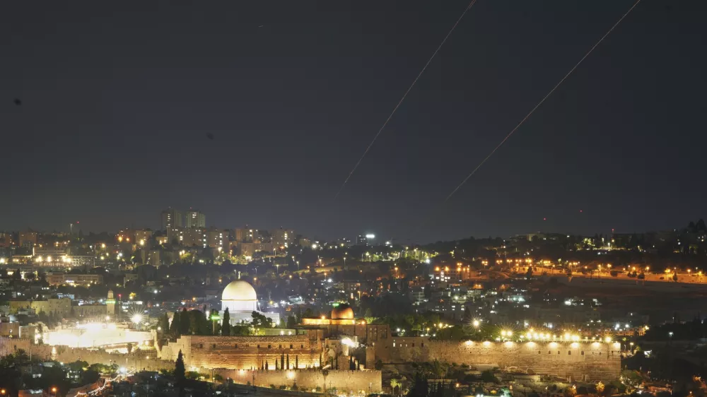 Traces are seen over Jerusalem during a missile attack alert, Friday, June 13, 2025. (AP Photo/Ohad Zwigenberg)