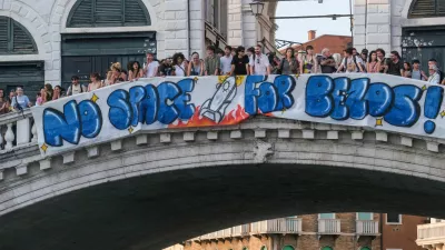 Protesters display a banner reading "No Space for Bezos!" on the Rialto Bridge during a protest against Amazon founder Jeff Bezos' upcoming wedding to Lauren Sanchez being held in Venice, Italy, June 13, 2025. REUTERS/Manuel Silvestri