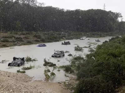 Multiple damaged cars are seen in flood waters Thursday, June 12, 2025, after heavy rains overnight in San Antonio. (Jessica Phelps/The San Antonio Express-News via AP)