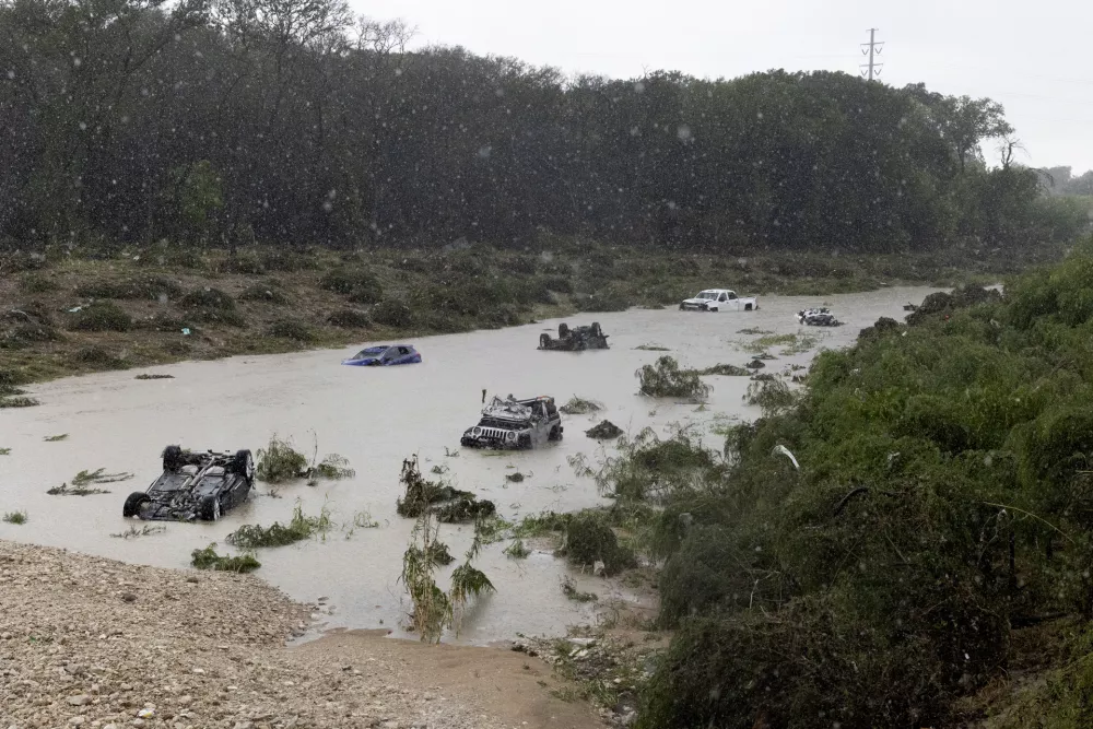 Multiple damaged cars are seen in flood waters Thursday, June 12, 2025, after heavy rains overnight in San Antonio. (Jessica Phelps/The San Antonio Express-News via AP)