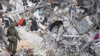 An Israeli military working dog searches rubble for survivors in a residential area hit by a missile fired from Iran, near Tel Aviv, Israel, Sunday, June 15, 2025.(AP Photo/Ariel Schalit)