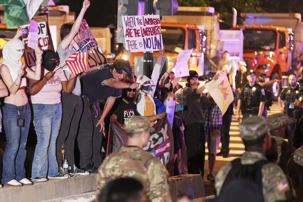 EDS NOTE: OBSCENITY Demonstrators yell during a demonstration against President Donald Trump policies in Washington, Saturday, June 14, 2025. (AP Photo/Matt Slocum)