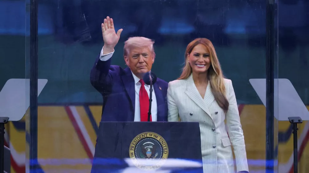 U.S. President Donald Trump waves next to first lady Melania Trump following the military parade to commemorate the U.S. Army's 250th Birthday, on the day of U.S. President Donald Trump 79th birthday, in Washington, D.C., U.S., June 14, 2025. REUTERS/Carlos Barria