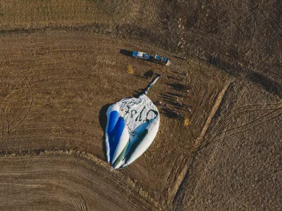 Goreme, Turkey - April 4, 2012: Hot air balloons for tourists flying over rock formations at sunrise in the valley of Cappadocia.