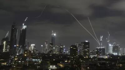 The Israeli Iron Dome air defense system fires to intercept missiles over Tel Aviv, Israel, Sunday, June 15, 2025. (AP Photo/Leo Correa)