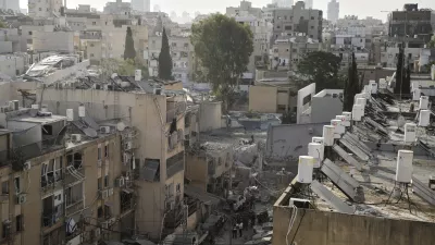 Rescue workers, police and military inspect the site where an Iranian missile struck in Bnei Brak, near Tel Aviv, Israel, Monday, June 16, 2025. (AP Photo/Leo Correa)