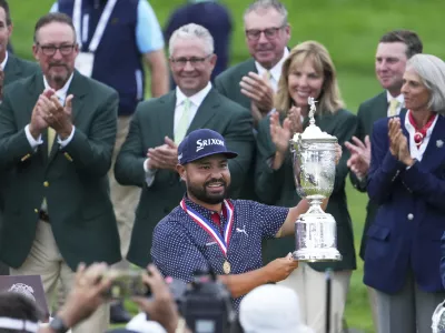 J.J. Spaun celebrates with the trophy after winning the U.S. Open golf tournament at Oakmont Country Club Sunday, June 15, 2025, in Oakmont, Pa. (AP Photo/Gene J. Puskar)