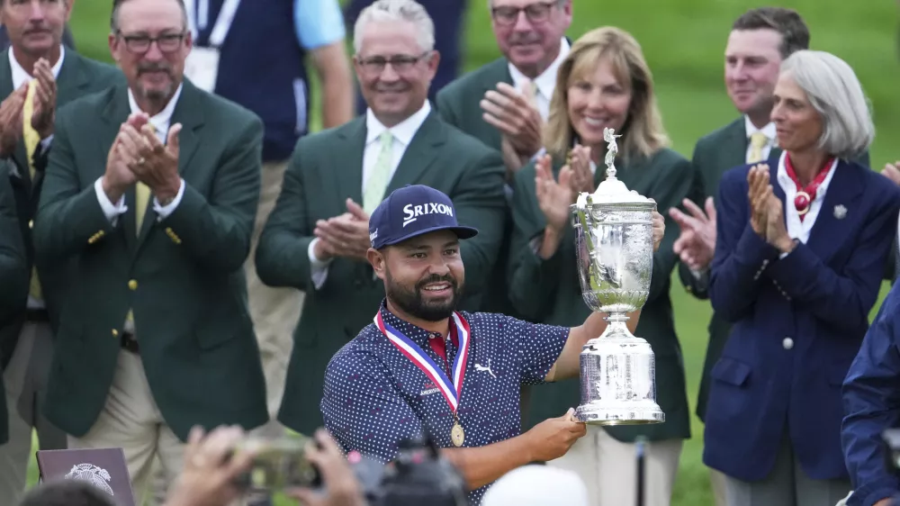 J.J. Spaun celebrates with the trophy after winning the U.S. Open golf tournament at Oakmont Country Club Sunday, June 15, 2025, in Oakmont, Pa. (AP Photo/Gene J. Puskar)