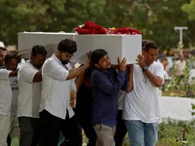 Relatives carry a coffin containing the remains of Rozar David Christian, who lost his life in an Air India Boeing 787-8 Dreamliner plane crash, for his burial at a cemetery, in Ahmedabad, India June 15, 2025. REUTERS/Amit Dave