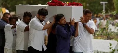 Relatives carry a coffin containing the remains of Rozar David Christian, who lost his life in an Air India Boeing 787-8 Dreamliner plane crash, for his burial at a cemetery, in Ahmedabad, India June 15, 2025. REUTERS/Amit Dave