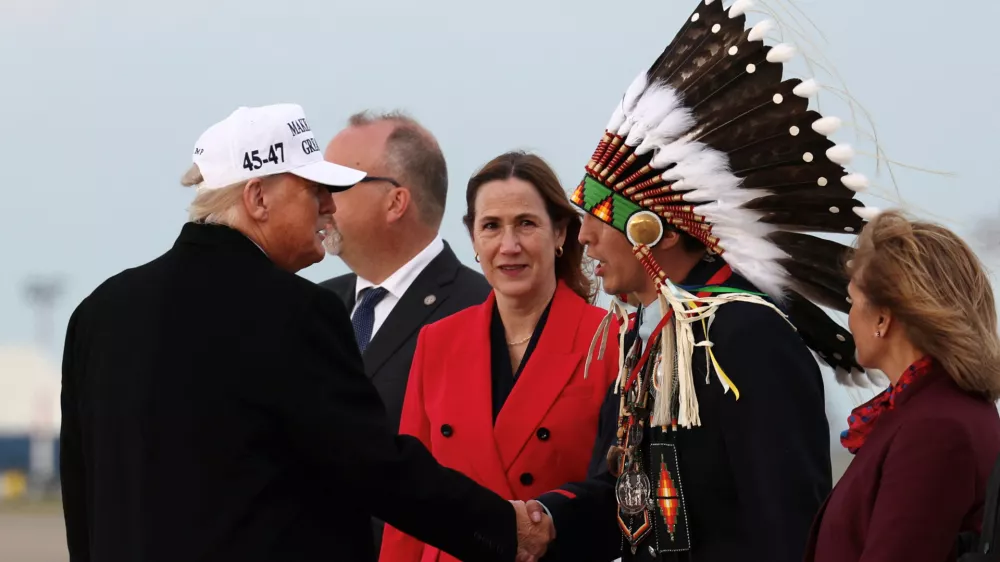 U.S. President Donald Trump and Tsuut'ina Minor Chief Steven Crowchild, Treaty 7 Representative, shake hands upon Trump's arrival to attend the G7 Leaders' Summit in the Rocky Mountain resort town of Kananaskis, at Calgary International Airport in Calgary, Alberta, Canada, June 15, 2025. REUTERS/Kevin Lamarque