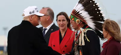 U.S. President Donald Trump and Tsuut'ina Minor Chief Steven Crowchild, Treaty 7 Representative, shake hands upon Trump's arrival to attend the G7 Leaders' Summit in the Rocky Mountain resort town of Kananaskis, at Calgary International Airport in Calgary, Alberta, Canada, June 15, 2025. REUTERS/Kevin Lamarque
