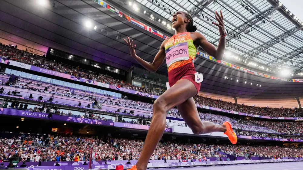 FILE - Faith Kipyegon, of Kenya, celebrates after winning the women's 1500-meter final at the 2024 Summer Olympics, Saturday, Aug. 10, 2024, in Saint-Denis, France.(AP Photo/David J. Phillip, File)