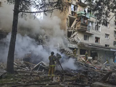 Firefighters put out the fire after a Russian missile hit a residential building during Russia's massive missile and drone air attack in Kyiv, Ukraine, Tuesday, June 17, 2025. (AP Photo/Efrem Lukatsky)