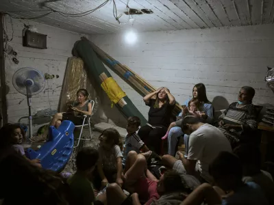 Israelis take shelter during air raid sirens warning of incoming strikes by Iran, in Bnei Brak, near Tel Aviv, Israel, Tuesday, June 17, 2025. (AP Photo/Oded Balilty)
