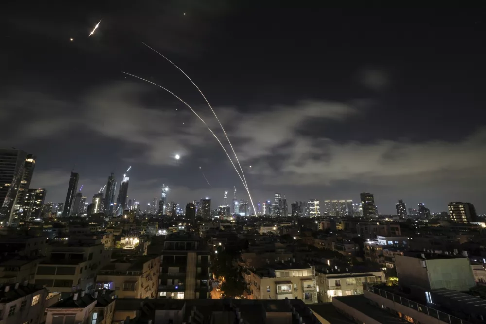 Israeli air defense system fires to intercept missiles during an Iranian attack over Tel Aviv, Israel, early Wednesday, June 18, 2025. (AP Photo/Leo Correa)