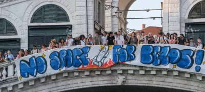 Protesters display a banner reading "No Space for Bezos!" on the Rialto Bridge during a protest against Amazon founder Jeff Bezos' upcoming wedding to Lauren Sanchez being held in Venice, Italy, June 13, 2025. REUTERS/Manuel Silvestri
