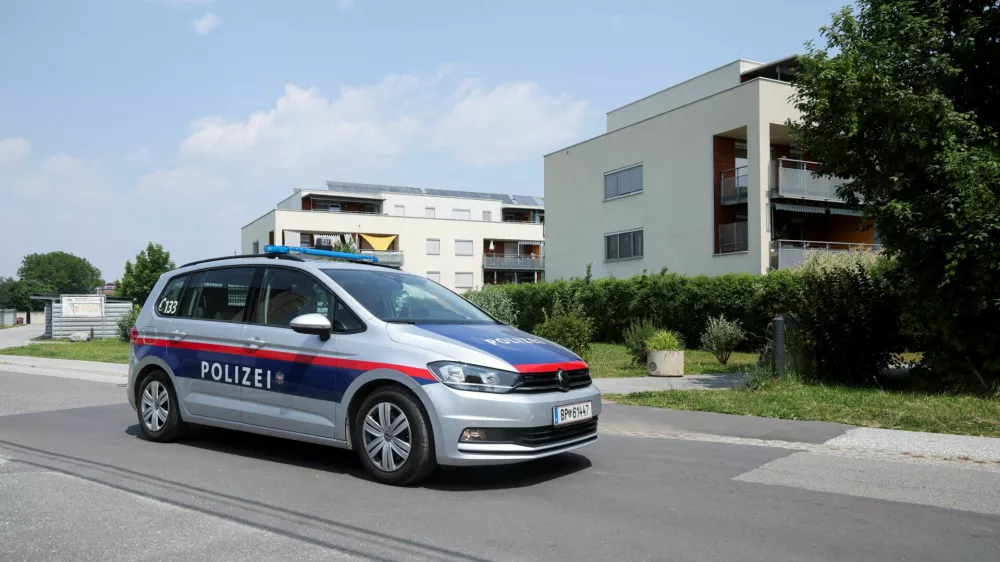 Police officers sit in a car near the flat of the suspect, in a deadly shooting at a secondary school in Graz, in Kalsdorf, Austria, June 11, 2025. REUTERS/Leonhard Foeger