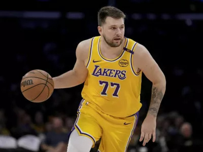Los Angeles Lakers guard Luka Doncic (77) dribbles up the court during the first half of Game 2 of an NBA first-round playoff series against the Minnesota Timberwolves in Los Angeles, Tuesday, April 22, 2025. (AP Photo/Eric Thayer)