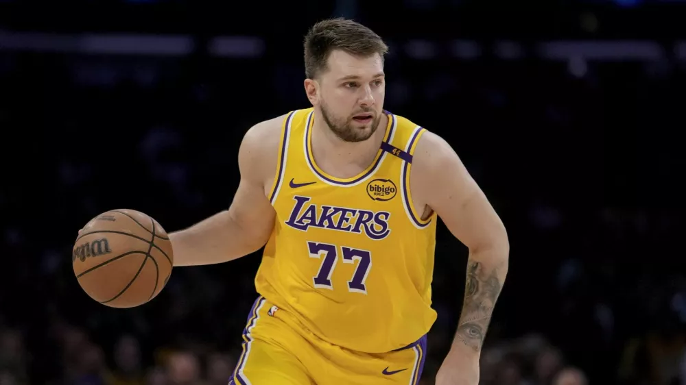 Los Angeles Lakers guard Luka Doncic (77) dribbles up the court during the first half of Game 2 of an NBA first-round playoff series against the Minnesota Timberwolves in Los Angeles, Tuesday, April 22, 2025. (AP Photo/Eric Thayer)