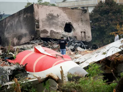 FILE PHOTO: FILE PHOTO: A fire officer stands next to the crashed Air India Boeing 787-8 Dreamliner aircraft, in Ahmedabad, India, June 13, 2025. REUTERS/Adnan Abidi/File Photo/File Photo