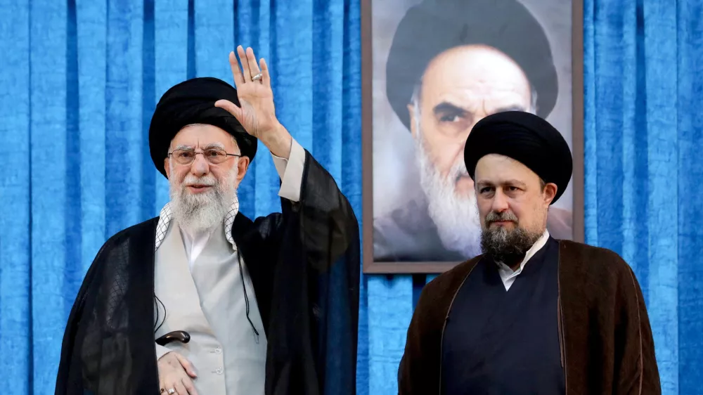 FILE PHOTO: Ayatollah Ruhollah Khomeini's grandson, Hassan Khomeini stands next to Iran's Supreme Leader Ayatollah Ali Khamenei during the 36th anniversary of the death of the leader of Iran's 1979 Islamic Revolution, Ayatollah Ruhollah Khomeini, at Khomeini's shrine in southern Tehran, Iran June 4, 2025. Office of the Iranian Supreme Leader/WANA (West Asia News Agency)/Handout via REUTERS ATTENTION EDITORS - THIS PICTURE WAS PROVIDED BY A THIRD PARTY/File photo