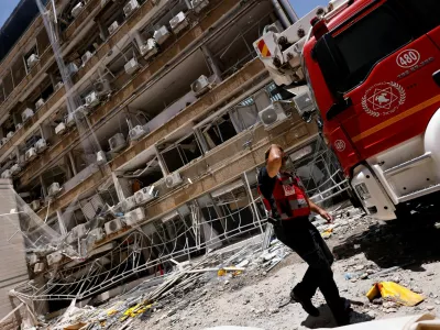 A rescuer walks at Soroka Medical Center, at an impact site following a missile strike from Iran on Israel, in Be'er Sheva, Israel June 19, 2025. REUTERS/Amir Cohen