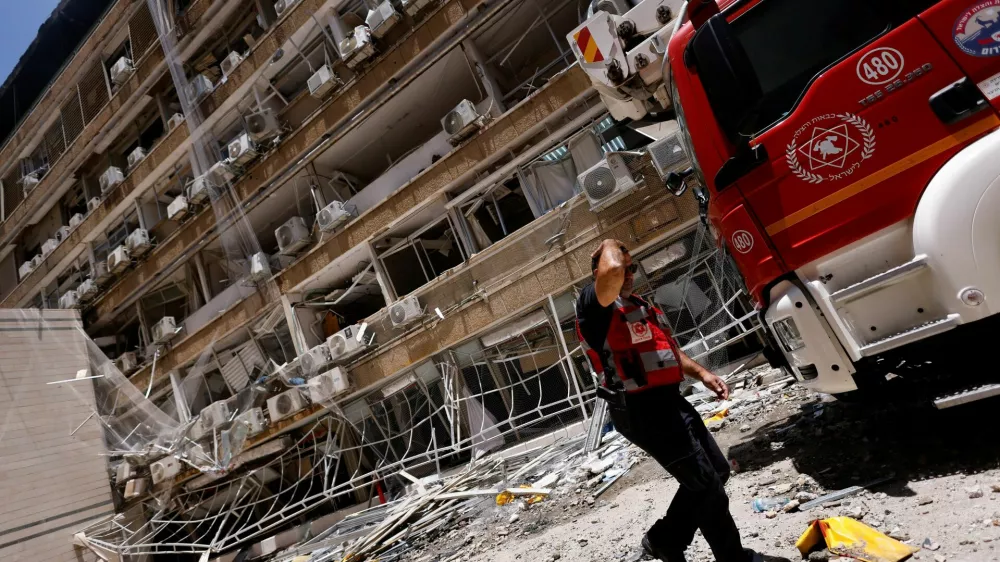 A rescuer walks at Soroka Medical Center, at an impact site following a missile strike from Iran on Israel, in Be'er Sheva, Israel June 19, 2025. REUTERS/Amir Cohen