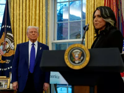 FILE PHOTO: U.S. President Donald Trump looks at Director of National Intelligence Tulsi Gabbard, on the day of Gabbard's swearing in ceremony, in the Oval Office at the White House in Washington, D.C., U.S., February 12, 2025. REUTERS/Nathan Howard/File Photo